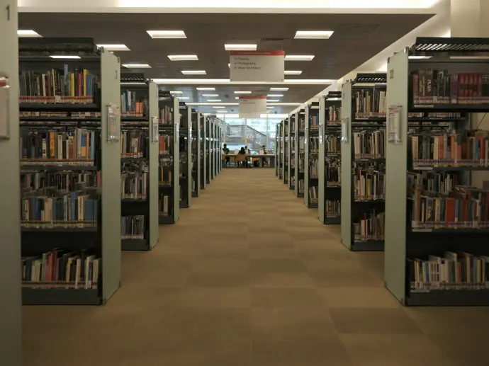 brown wooden book shelves on brown floor tiles